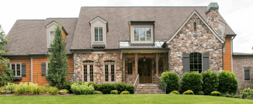 A skilled professional in Edmonton, AB using color-matching techniques to restore the natural look of a stone wall. The restored section seamlessly blends with the existing stonework, while texture restoration tools are used to maintain consistency.