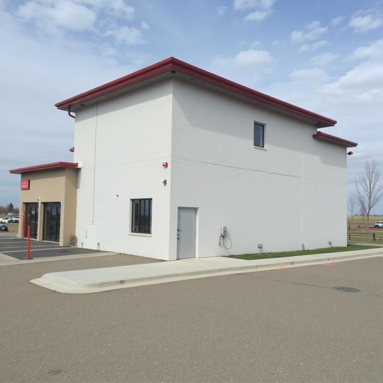 EIFS stucco installed by Depend Exteriors on a commercial building in Nisku AB, highlighting a seamless finish, mouldings, and joint detailing.