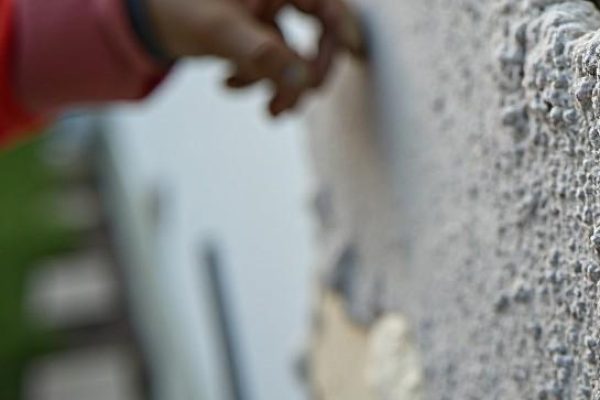 EIFS repair work in Beaumont AB by Depend Exteriors—base coat being applied over mesh to restore a damaged stucco surface with precision.