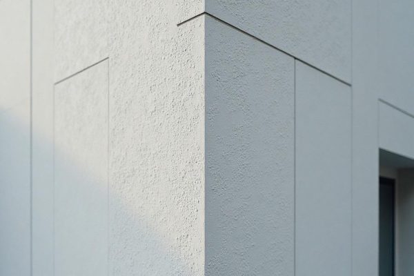 EIFS repair in progress on a home in Nisku AB by Depend Exteriors, showing patched insulation and base coat blending with original wall.