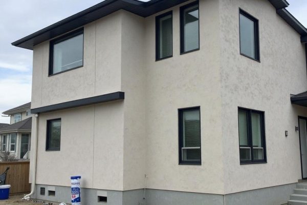 Stucco Contractor Beaumont Alberta | Depend Exteriors EIFS stucco application in progress on a residential property in Beaumont AB by Depend Exteriors, showing multi-layered insulation and textured wall finish.
