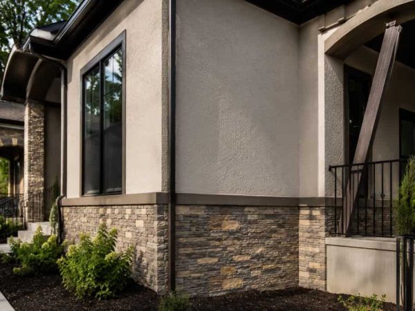 Modern home with smooth stucco walls and stone masonry veneer by a Stucco Contractor and Masonry Company Hermitage.