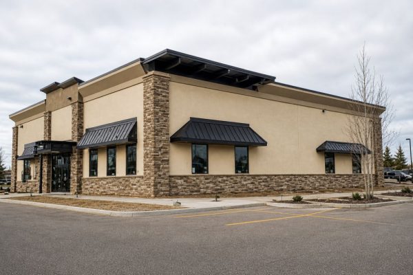 Professional stucco contractor in Terwillegar AB showcasing a completed commercial exterior with clean stucco finish, stone detailing, and strong protection against Alberta weather conditions
